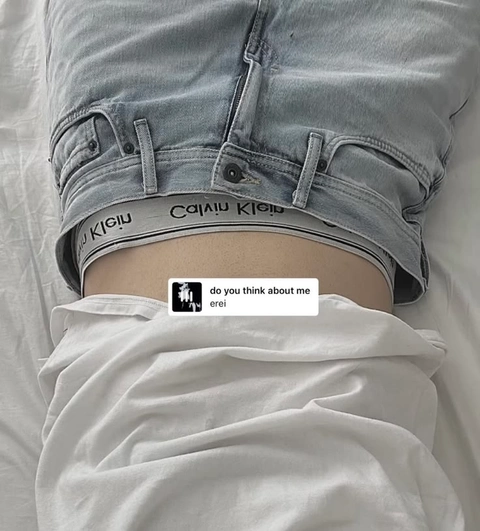 A pair of jeans with a picture of a person's stomach.