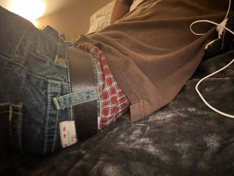 A pair of jeans with a red and black plaid shirt.