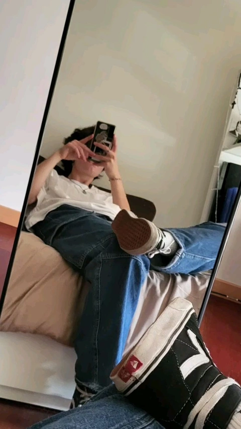 A woman taking a picture of herself in a mirror.