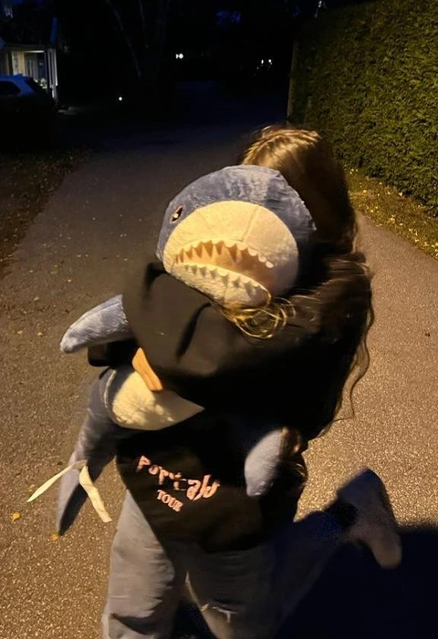 A person holding a stuffed animal in their hands.