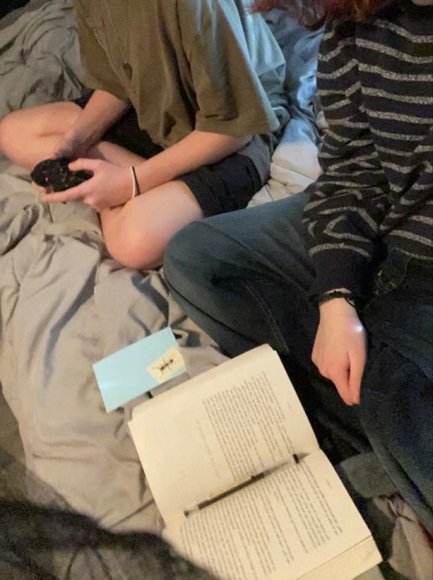 A group of people sitting on top of a bed.