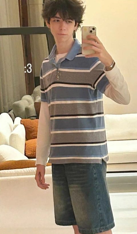 A young man taking a selfie in a mirror.