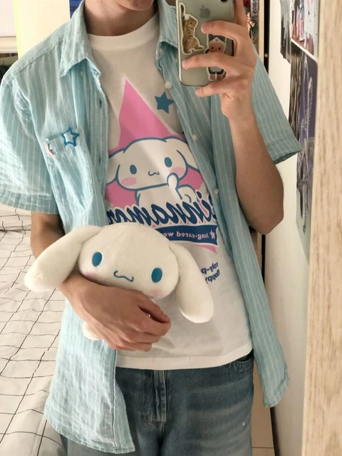 A man taking a picture of himself with a stuffed animal.