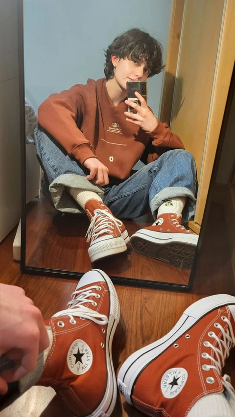 A man taking a picture of himself in a mirror.