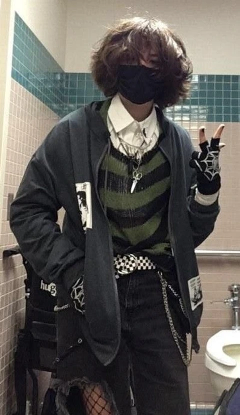 A man in a bathroom with a mask on his face.
