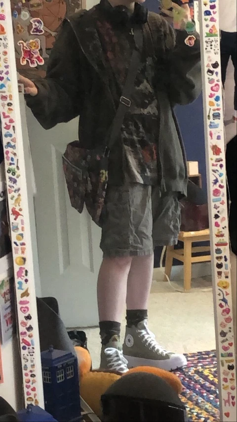 A mannequin dressed in a camouflage outfit and boots.