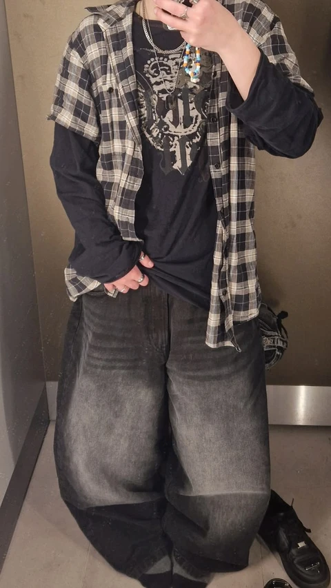 A mannequin wearing a plaid shirt and jeans.