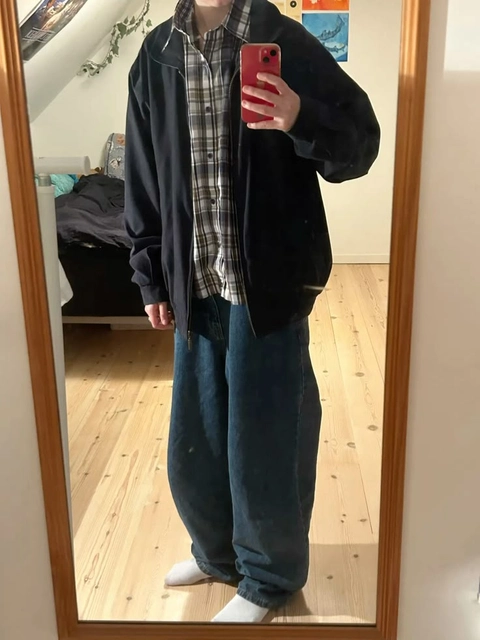 A man taking a selfie in a mirror.