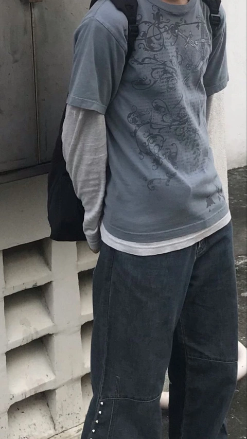 A mannequin wearing a gray shirt and black pants.