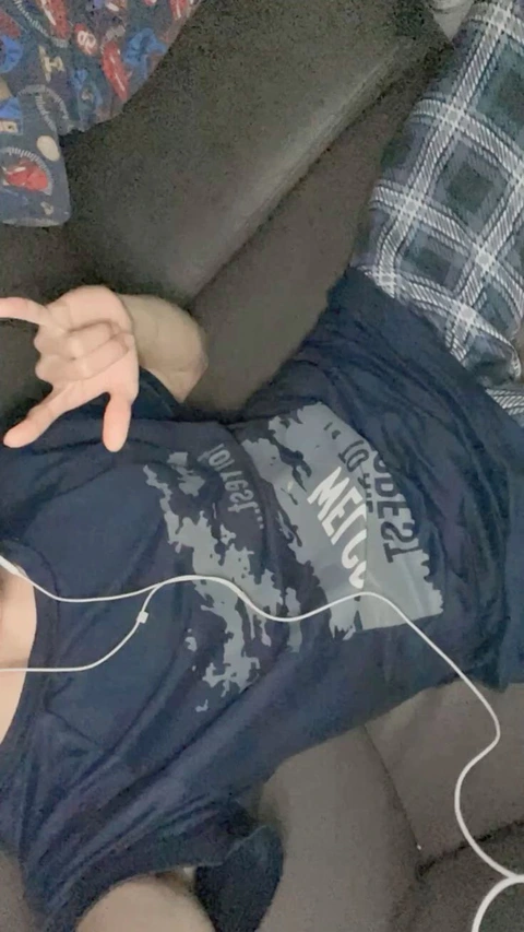 A person holding a pair of headphones in their hands.