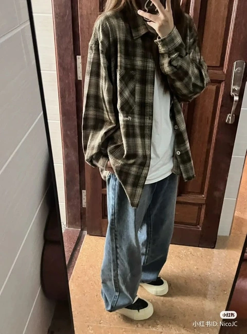 A woman taking a picture of herself in a mirror.
