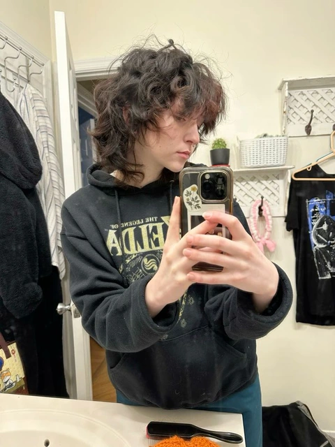 A woman taking a picture of herself in a mirror.