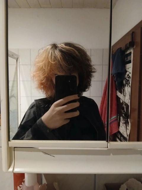 A woman taking a picture of herself in a mirror.