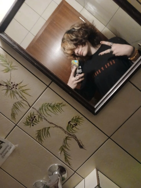 A reflection of a woman taking a picture of herself in a mirror.