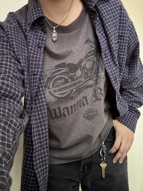 A man wearing a shirt with a motorcycle on it.