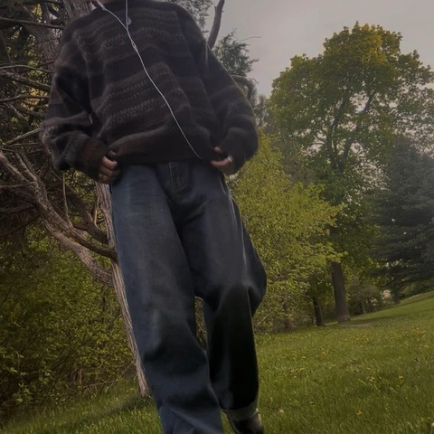 A man standing in the middle of a grassy field.