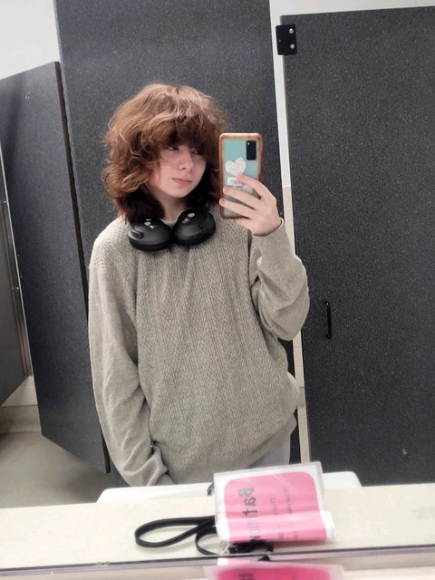 A woman taking a picture of herself in a mirror.