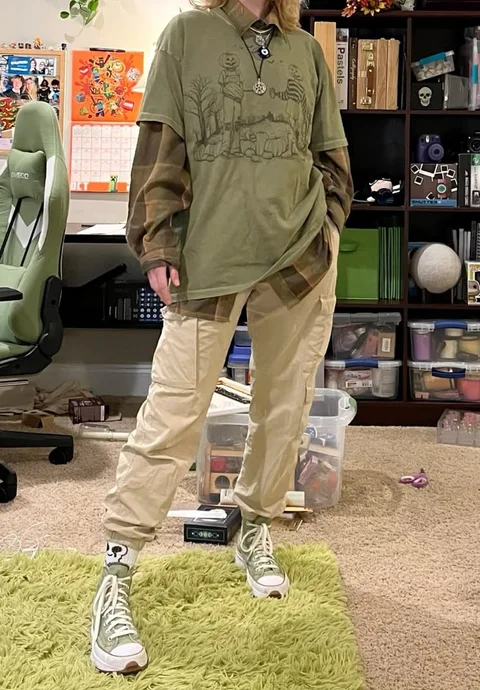 A man standing on top of a green rug in a room.