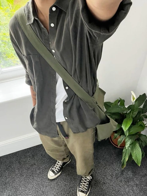 A mannequin wearing a green shirt and pants.