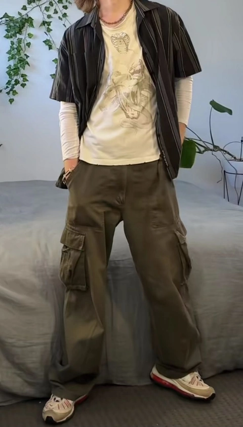 A mannequin wearing a white shirt and brown pants.