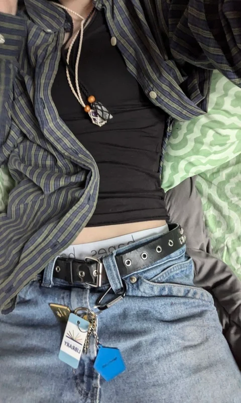 A woman wearing a black shirt and blue jeans.