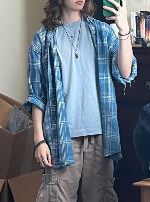 A mannequin wearing a blue and white plaid shirt.