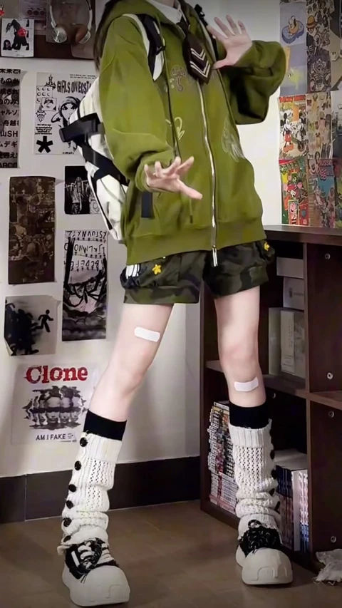 A mannequin wearing a green jacket and shorts.