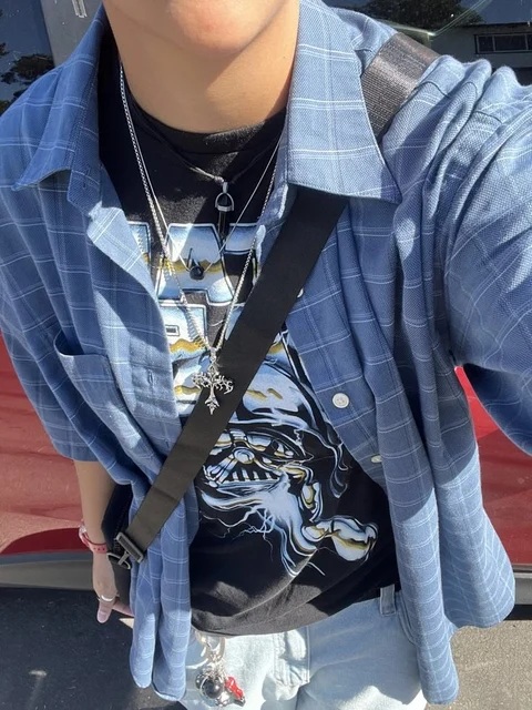 A woman wearing a black shirt with a skull on it.