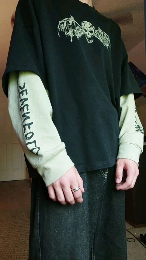 A man wearing a black shirt with a skull on it.